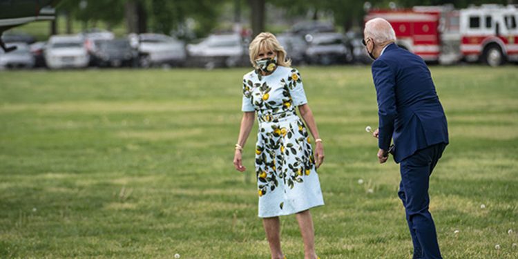 WASHINGTON, DC - APRIL 29: U.S. President Joe Biden picks a dandelion for first lady Jill Biden as they walk to Marine One on the Ellipse near the White House on April 29, 2021 in Washington, DC. President Biden and the first lady will spend the day in Georgia to commemorate the first 100 days in office and to visit former President Jimmy Carter. (Photo by Sarah Silbiger/Getty Images)