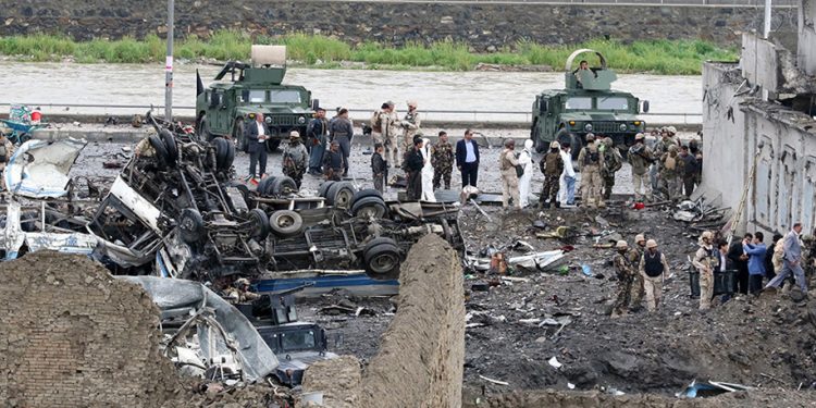 epa05266514 Afghan security officials inspect the site of a suicide bomb blast that targeted the premises of the Ministry of Defense, in Kabul, Afghanistan, 19 April 2016. A huge explosion rocked Kabul as Taliban militants attacked the Afghan Ministry of Defense days after they announced their spring offensive.  EPA/HEDAYATULLAH AMID