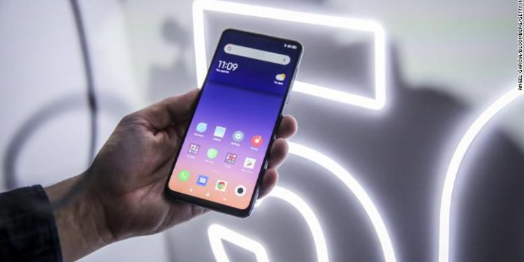 An attendee handles a Mi Mix 3 5G smartphone on display during a Xiaomi Corp. launch event ahead of the MWC Barcelona in Barcelona, Spain, on Sunday, Feb. 24, 2019. At the wireless industry???s biggest conference, over 100,000 people are set to see the latest innovations in smartphones, artificial intelligence devices and autonomous drones exhibited by more than 2,400 companies. Photographer: Angel Garcia/Bloomberg