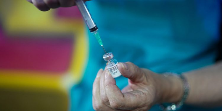 HALIFAX, ENGLAND - JULY 31: Dr Lisa Pickles draws up the Pfizer-BioNTech COVID-19 vaccine at a new ‘Pop Up’ vaccination centre in the Big Top of Circus Extreme in Shibden Park on July 31, 2021 in Halifax, England. The pop-up clinic will be situated just outside the UKs largest circus Big Top so even people who do not have tickets to the show will still be able to get their vaccine. All adults in England have been able to book a first dose since June 18, but the latest figures show that nearly a third of young adults (aged 18 to 29) in the country have still not had one. (Photo by Ian Forsyth/Getty Images)