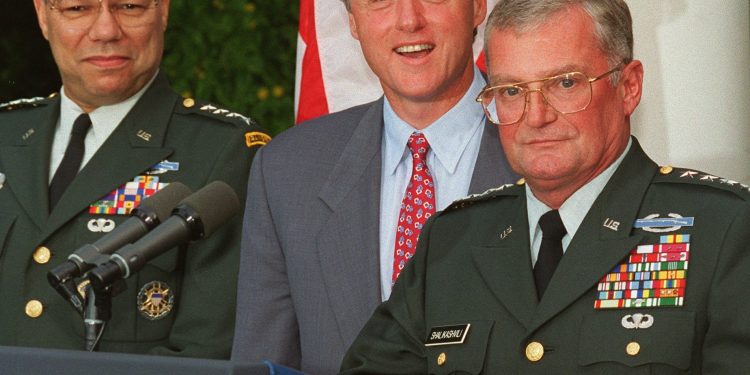 ORG XMIT: NYJS101 FILE - In this Aug. 11, 1993 file photo, Army Gen. John Shalikashvili speaks in the Rose Garden of the White House in Washington accompanied by President Bill Clinton and Joint Chiefs Chairman Gen. Colin Powell. On Saturday, July 23, 2011, the White House said Retired Gen. Shalikashvili, former chairman of the Joint Chiefs of Staff, has died. (AP Photo/Doug Mills, File)