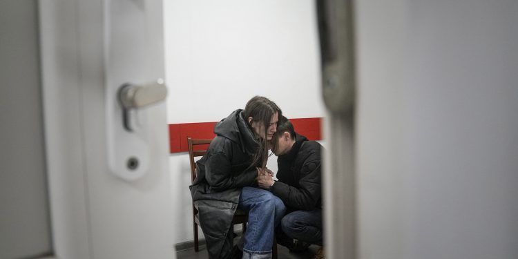 Marina Yatsko and her boyfriend Fedor comfort each other after her 18-month-old son Kirill was killed by shelling in a hospital in Mariupol, Ukraine, Friday, March 4, 2022. (AP Photo/Evgeniy Maloletka)