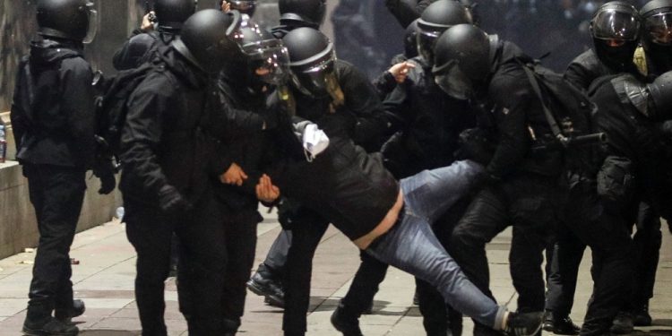 epa11755464 Police officers detain a protester during Georgian opposition supporters protest in front of the Parliament building in Tbilisi, Georgia, 03 December 2024. Thousands of pro-EU activists continue their protests in the Georgian capital against the country's ruling party decision to suspend accession talks with the European Union (EU) until the end of 2028.  EPA-EFE/DAVID MDZINARISHVILI