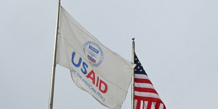 A USAID and American flag fly before Congressional Democrats hold news conference outside of United States Agency for International Development (USAID) headquarters in Washington, DC, on February 3, 2025. US Secretary of State Marco Rubio said Monday he had been put in charge of the US aid agency, saying he would stop its "insubordination" to President Donald Trump's agenda. After Trump's billionaire friend and advisor Elon Musk vowed to destroy the US Agency for International Development (USAID), whose website went dark over the weekend, Rubio confirmed he and the State Department had assumed control of the autonomous body. (Photo by Mandel NGAN / AFP)